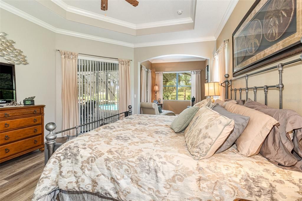 Master Bedroom with views to the Lanai, Pool, and the Golf Course in the distance