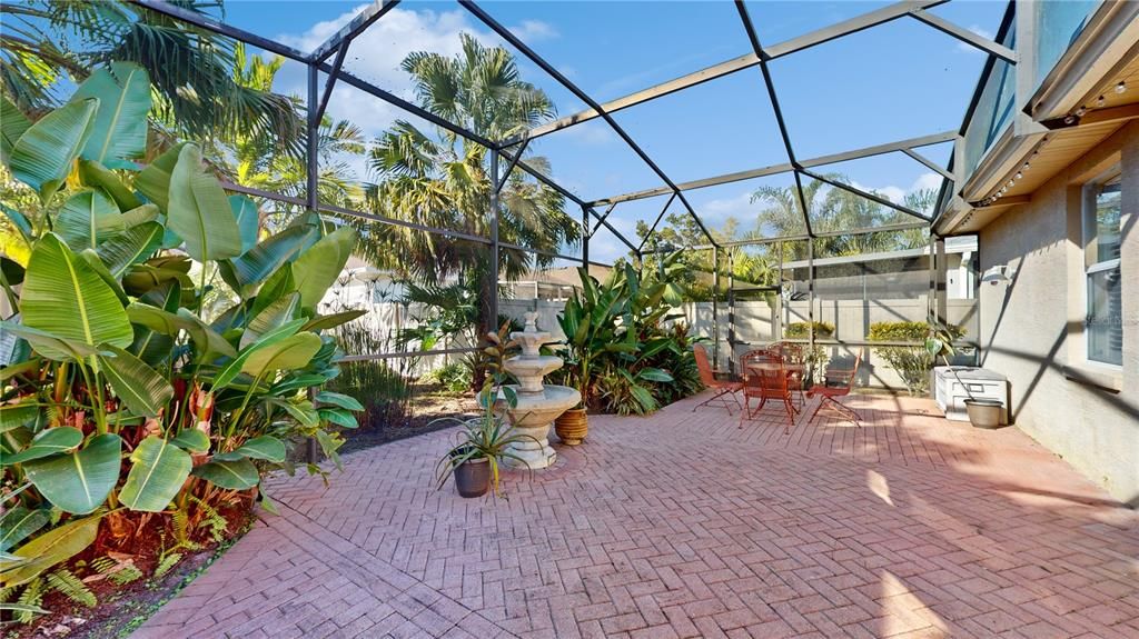 SCREENED PORCH WITH PAVERS AND FOUNTAIN