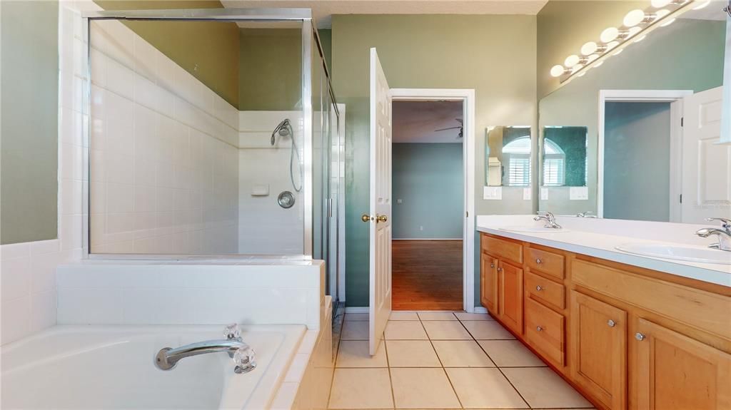 PRIMARY BATHROOM WITH GARDEN TUB AND SHOWER.