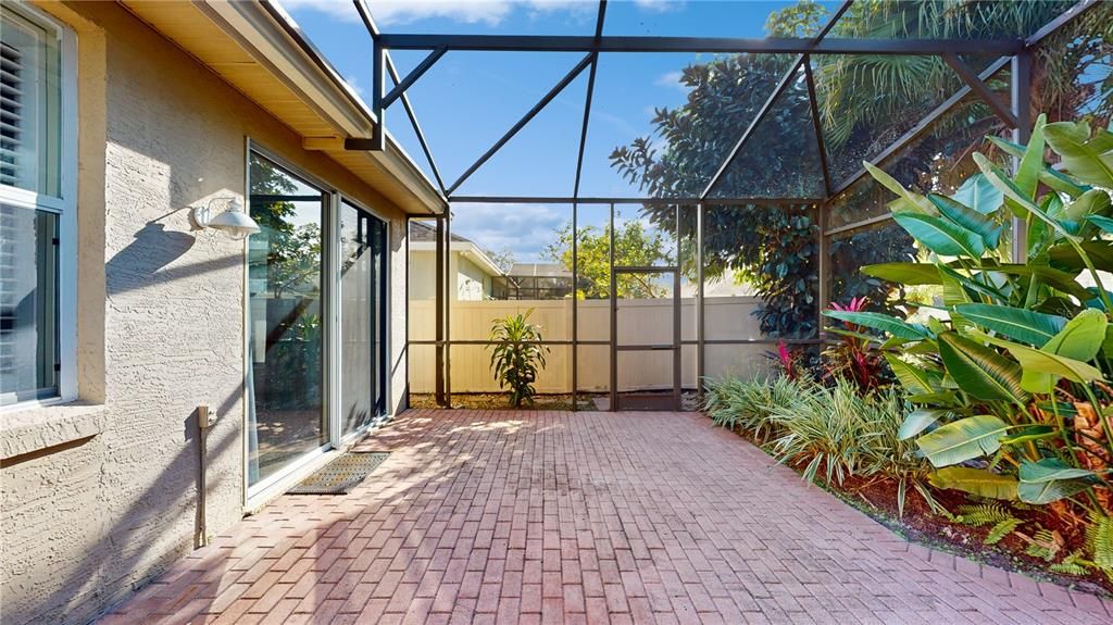 SCREEND PORCH WITH LUSH TROPICAL LANDSCAPING