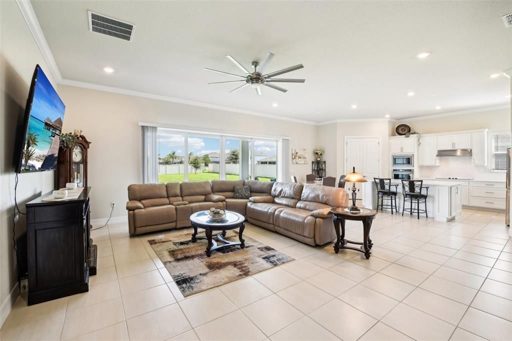 The wall of sliding glass doors off the living area lets the NATURAL LIGHT pour in creating a warm and inviting atmosphere for friends and family alike.