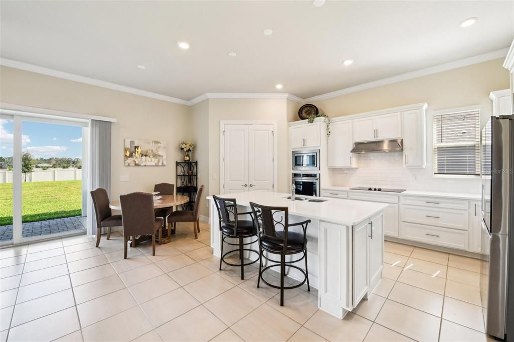 The kitchen is what home chef’s dream about delivering a great mix of cabinet and drawer storage, crown molding, UPGRADED STAINLESS STEEL APPLIANCES, tiled backsplash, WALK-IN PANTRY and breakfast bar seating on the large ISLAND!