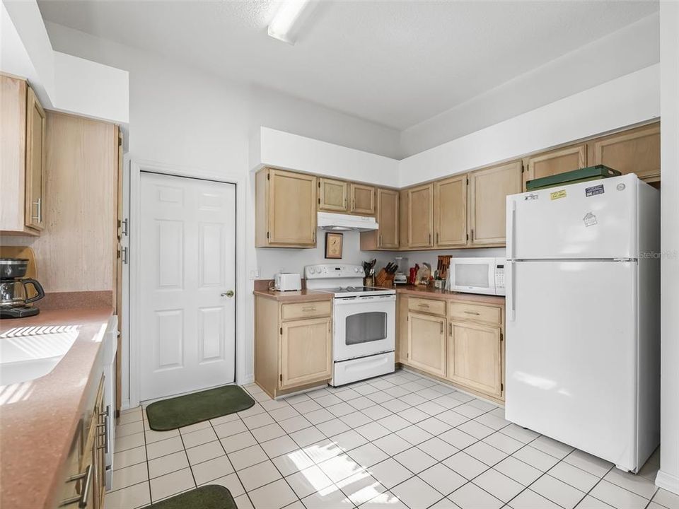 Door in The Kitchen leads to the Garage. Additionally, there is one in the Laundry Room too