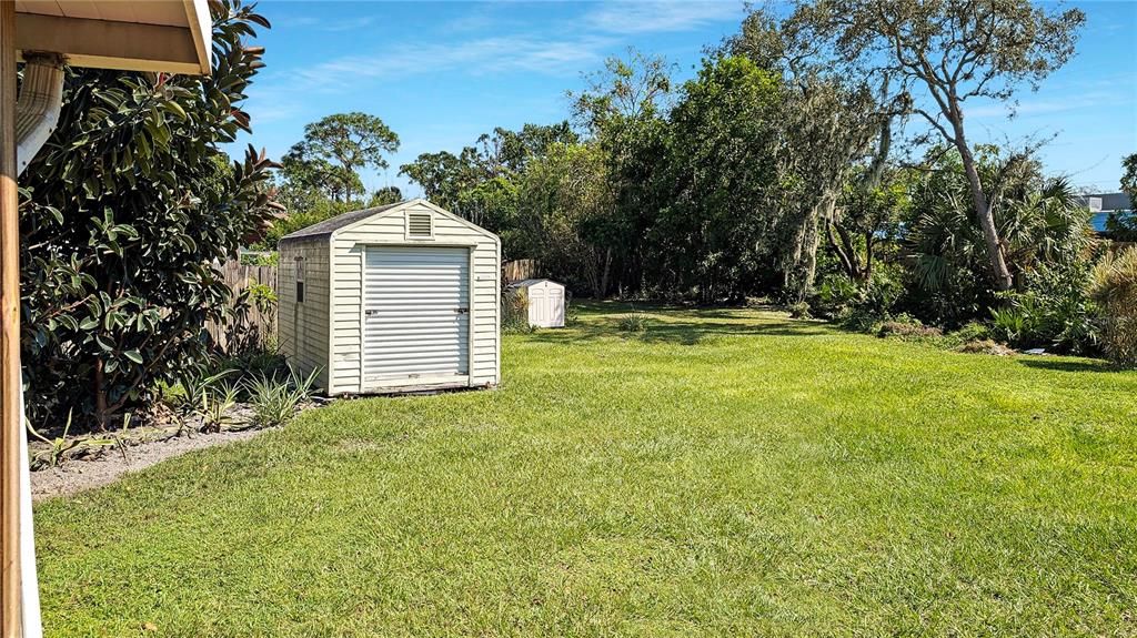 Your SCREENED BACK PORCH overlooks an Expansive Yard that goes WAAYYY Back (the Largest Lot in the Community) …with TWO Storage Sheds as Well! Bonus!