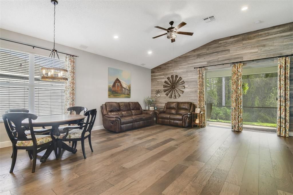 The breakfast bar and dinette provide casual dining options all open to a spacious living area with a wood accent wall that brings a modern farmhouse vibe and perfectly frames the WOODED VIEW through sliding glass doors!