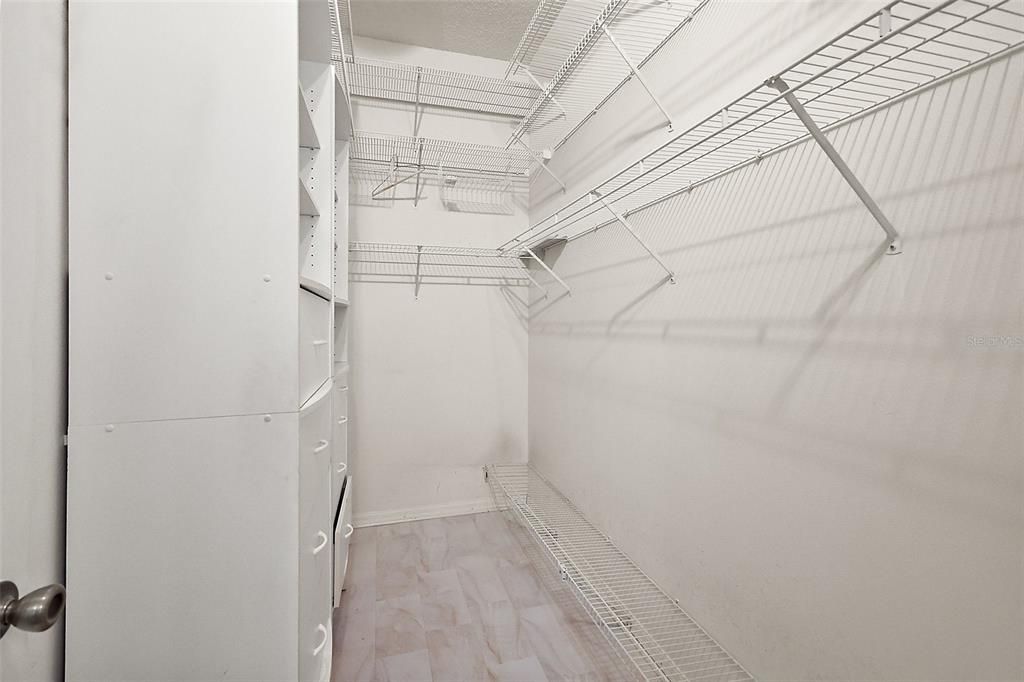 Large Primary Bdrm closet with custom shelving & drawers