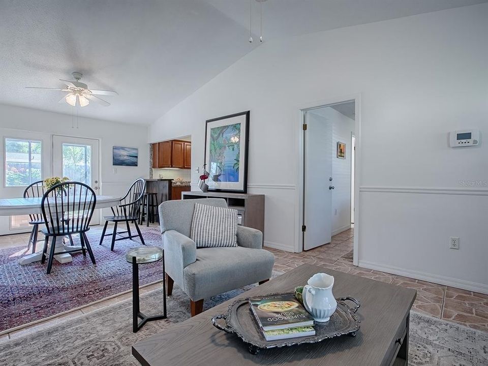 A flowing space connects the living room and dining area ~