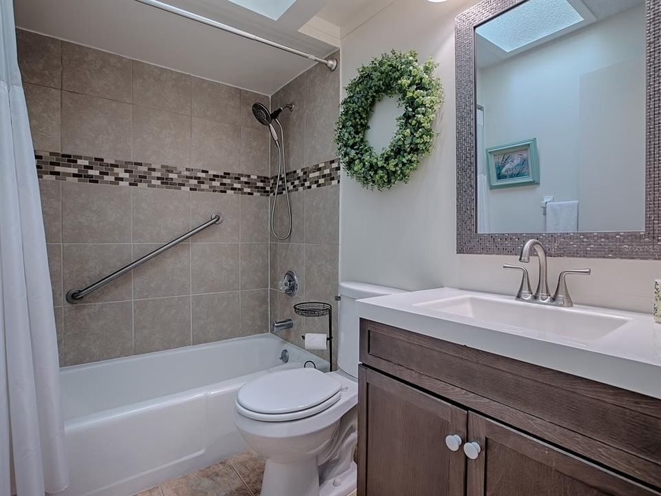 Hall bath with a stylish updated vanity ~