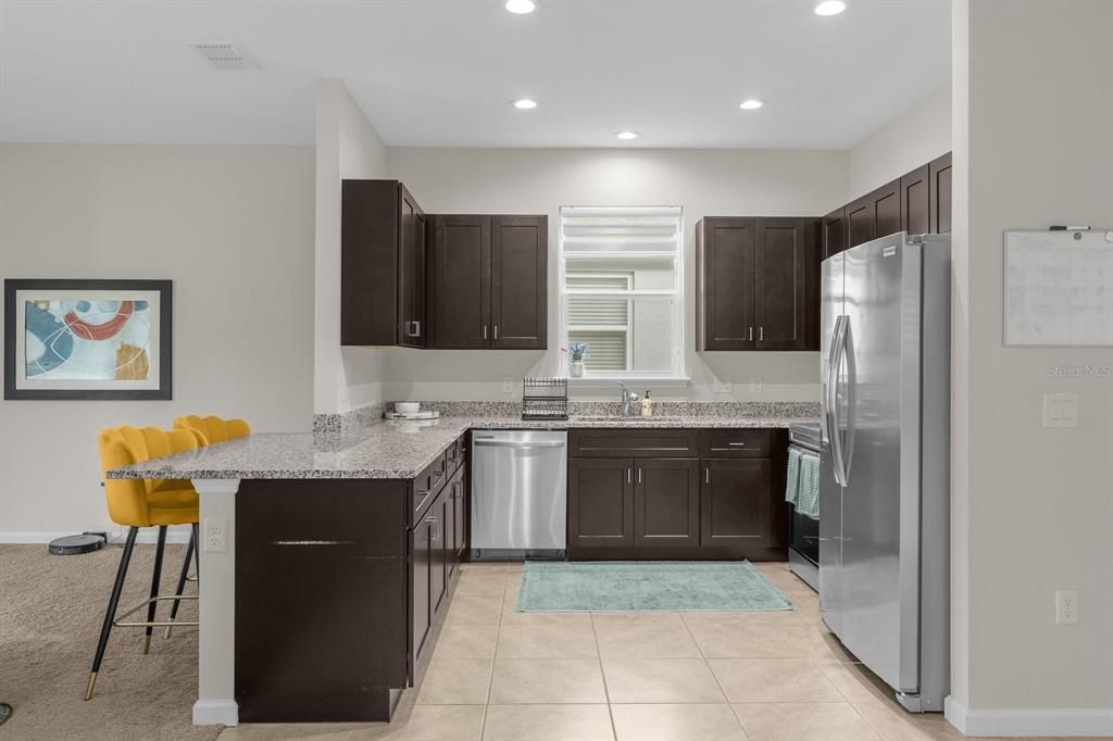 Kitchen with solid wood cabinets and stainless steel appliances