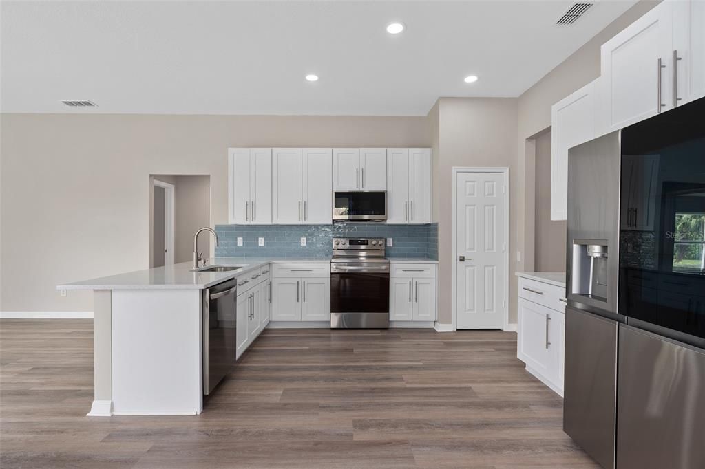 KITCHEN HAS BEEN DONE WITH ALL HARDWOOD CABINETS WITH DOVETAIL DRAWERS AND CONSTRUCTION. CUSTOM HANDLES HAVE BEEN INSTALLED AS WELL. THE COUNTERTOPS ARE QUARTZ, A DEEP DISH SINK, HIGH END STAINLESS LG APPLIANCES, THE FRIDGE IS A SEE THROUGH DOOR FRIDGE THAT MAKES SPECIALTY CRAFT ICE, THE RANGE HAS CONVECTION AND AN AIR FRYER,  THE DISHWASHER IS A STAINLESS STEEL TUB DISHWASHER. THE CUSTOM BACKSPLASH HAS BEEN LAID TO PERFECTION. ALL THE LIGHTING IN THE HOME HAS BEEN UPGRADED AS WELL.