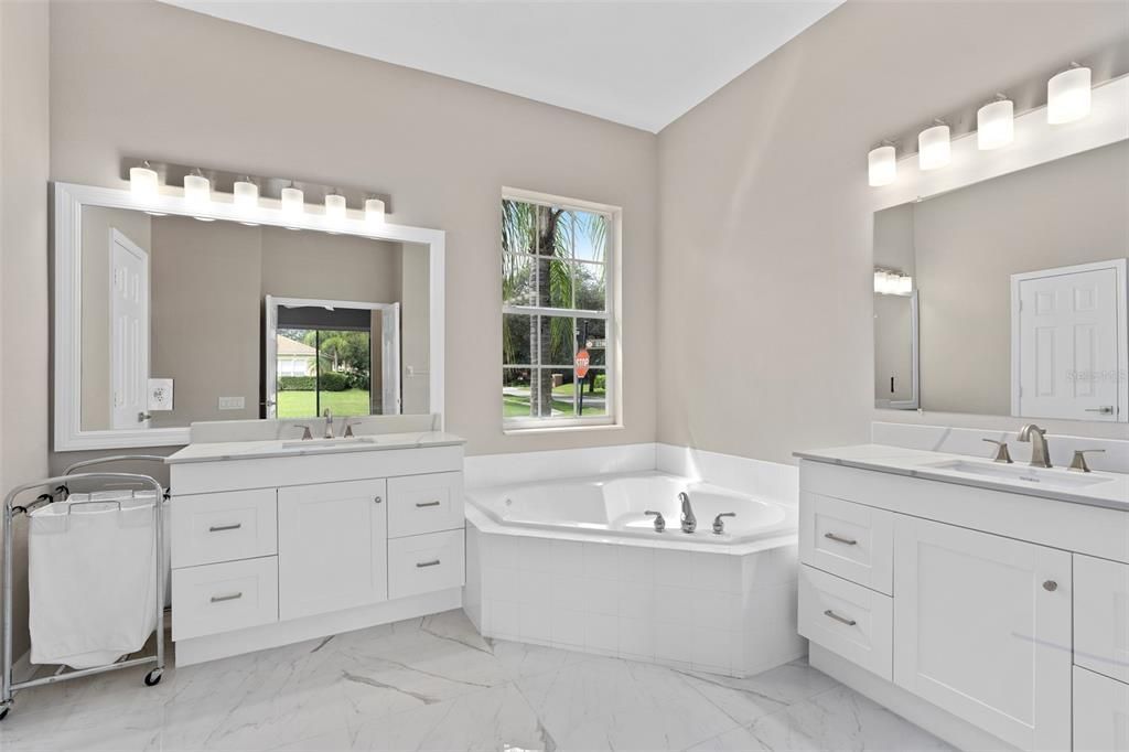 MASTER BATHROOM REMODELED WITH 24 INCH PORCELAIN TILE, ALL NEW VANITIES WITH STONE COUNTERTOPS, NEW LIGHTING ETC