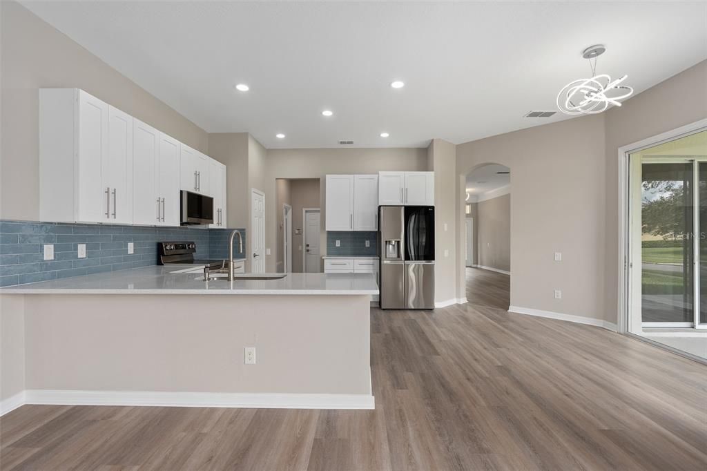 KITCHEN HAS BEEN DONE WITH ALL HARDWOOD CABINETS WITH DOVETAIL DRAWERS AND CONSTRUCTION. CUSTOM HANDLES HAVE BEEN INSTALLED AS WELL. THE COUNTERTOPS ARE QUARTZ, A DEEP DISH SINK, HIGH END STAINLESS LG APPLIANCES, THE FRIDGE IS A SEE THROUGH DOOR FRIDGE THAT MAKES SPECIALTY CRAFT ICE, THE RANGE HAS CONVECTION AND AN AIR FRYER,  THE DISHWASHER IS A STAINLESS STEEL TUB DISHWASHER. THE CUSTOM BACKSPLASH HAS BEEN LAID TO PERFECTION. ALL THE LIGHTING IN THE HOME HAS BEEN UPGRADED AS WELL.