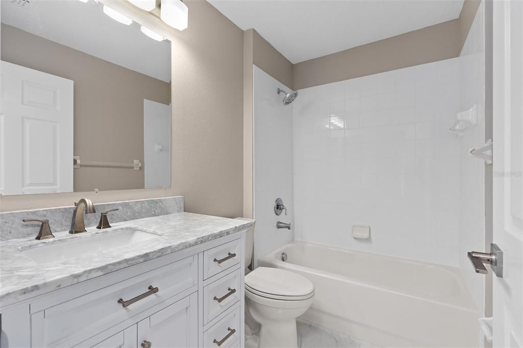 BATHROOM 2 REMODELED WITH NEW VANITIES, 24 INCH PORCELAIN TILE, NEW TOILET, CUSTOM LIGHTING, ALL NEW FAUCETS, ETC