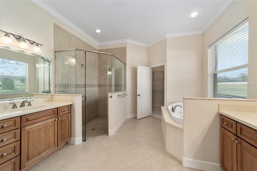 Primary bath with 2 walk in closets, water closet and linen closet. Dual sinks-separate vanities. This bathroom has a dedicated tankless water heater.