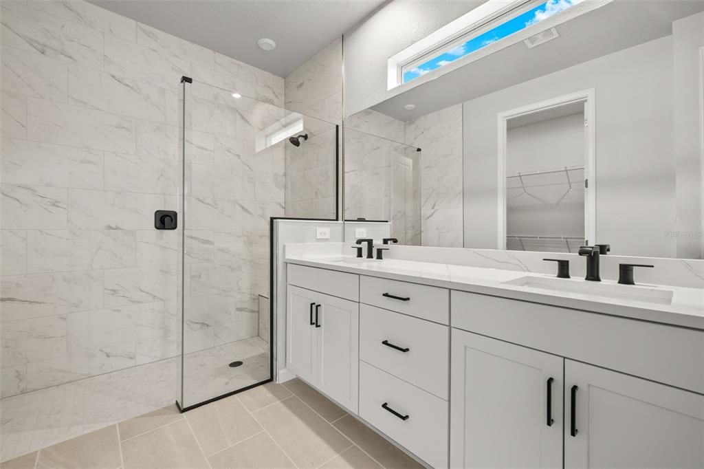 Owner's Bathroom with Double Sink Vanity and Shower