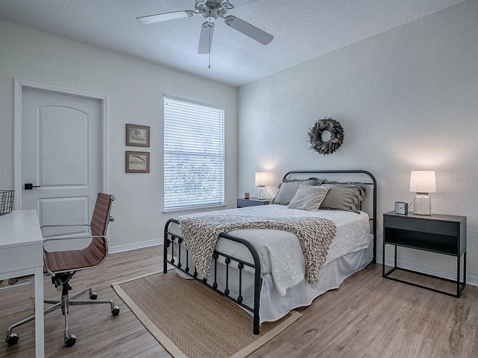 Guest Bedroom featuring a walk-in closet and Luxury Vinyl Plank Flooring