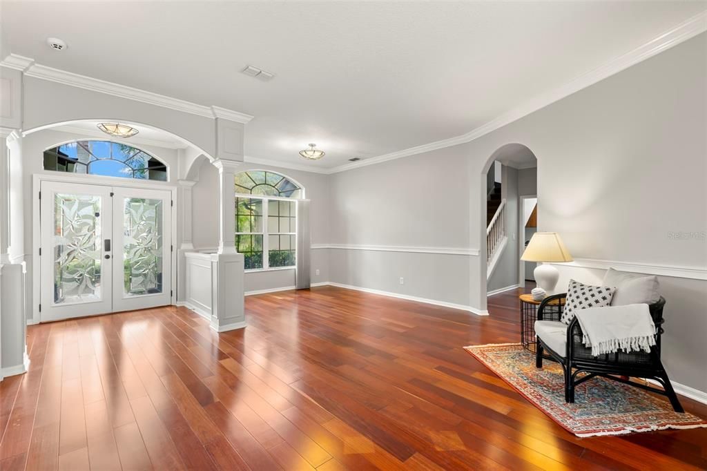 Enter through the front etched glass double doors into the formal living room and dining room with gorgeous cherry wood floors and high ceilings.