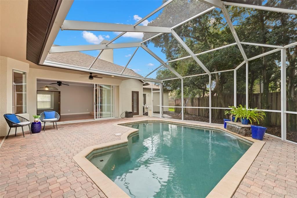 Enjoy the Florida weather year round under the two new outdoor fans with the peaceful flow of the waterfall in the background or soak up some rays in the sparking pool.