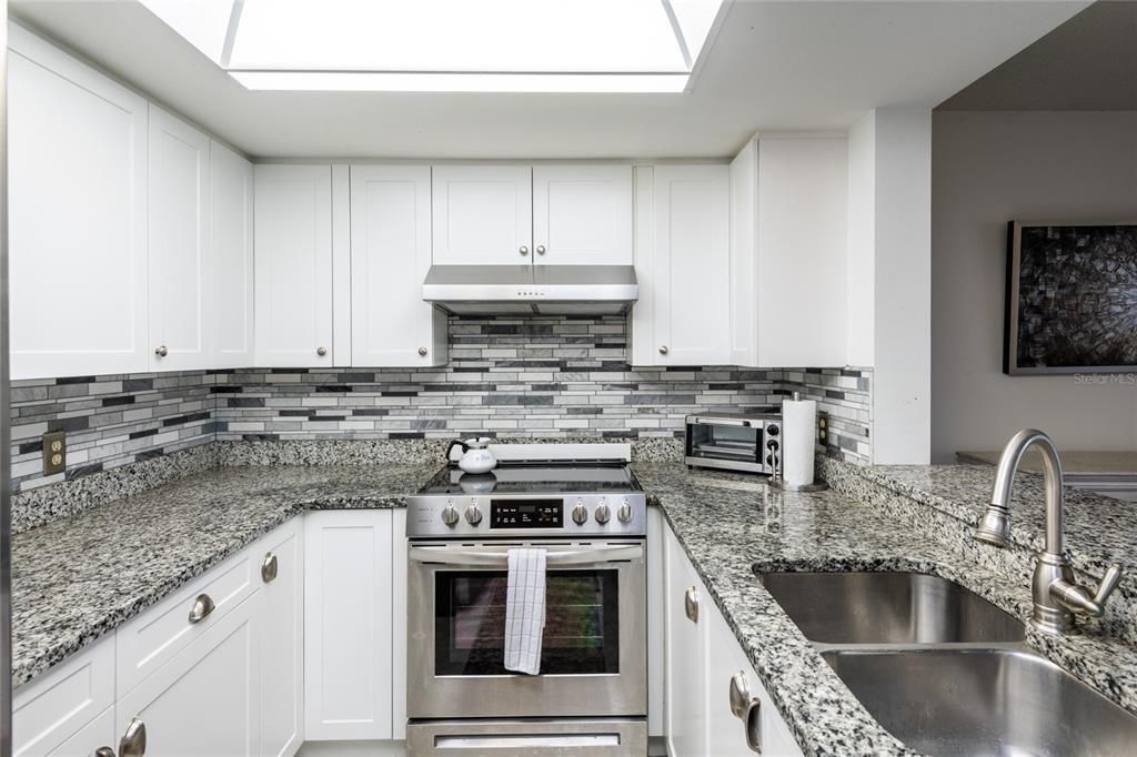 Upgraded kitchen with custom backsplash.