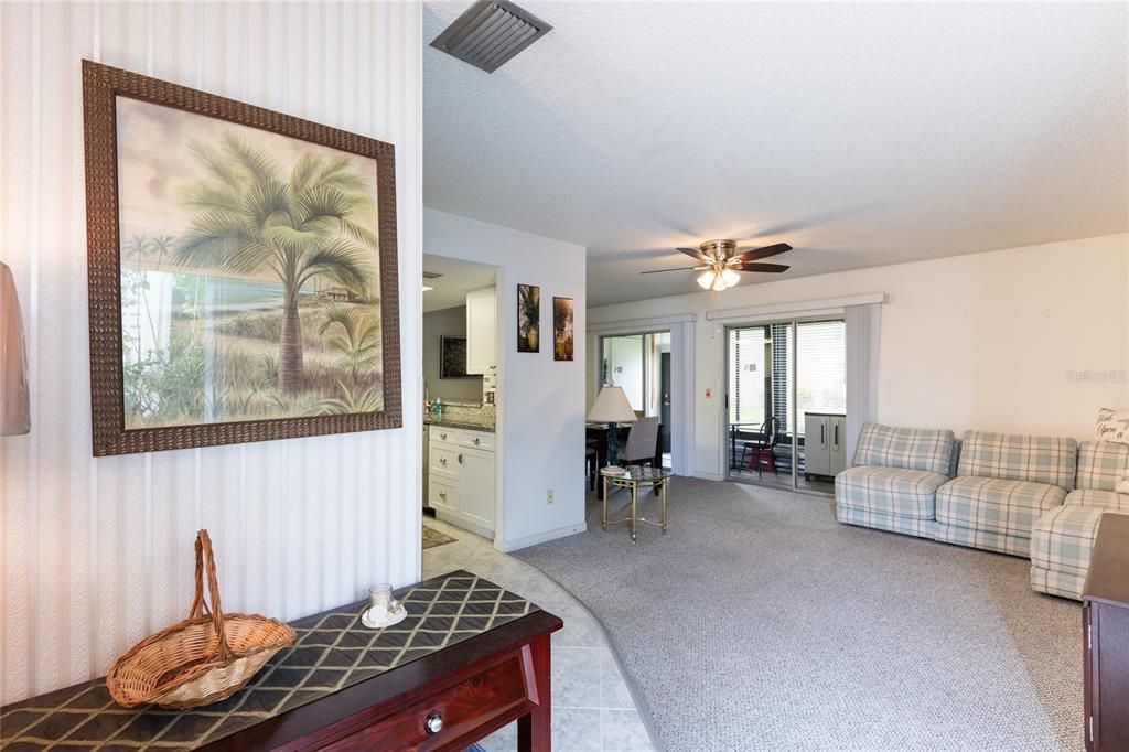 Living room with carpet and sliding doors to the Lanai