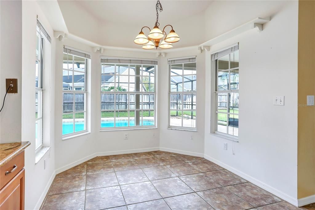 Eating space in the kitchen overlooking the sparkling solar heated pool and lanai.