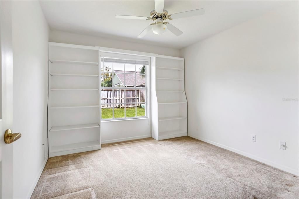 Bedroom 3 with built in shelves.