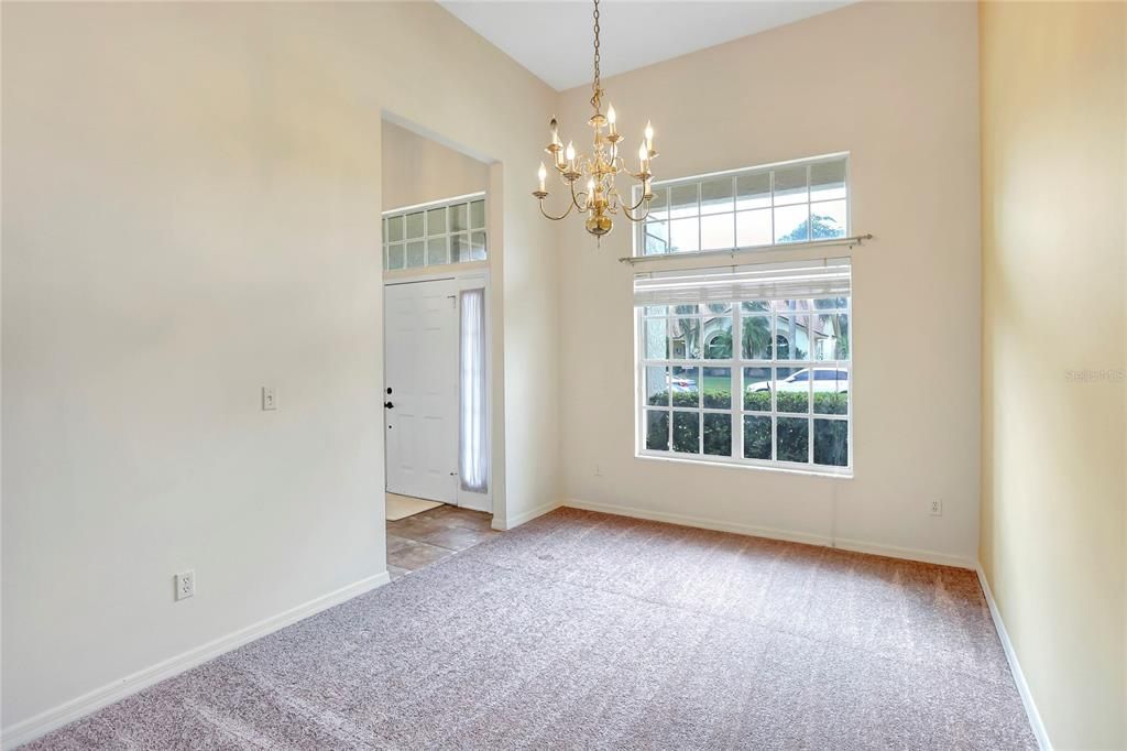 Formal dining room to the left of the foyer with new carpet.