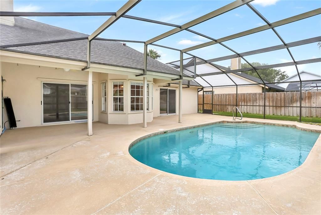 Solar heated pool with child safety fence.