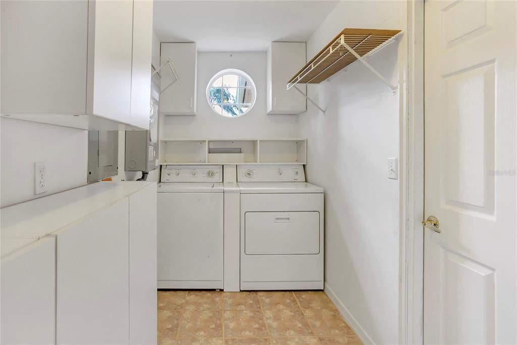 Indoor laundry room with plenty of storage cabinets.