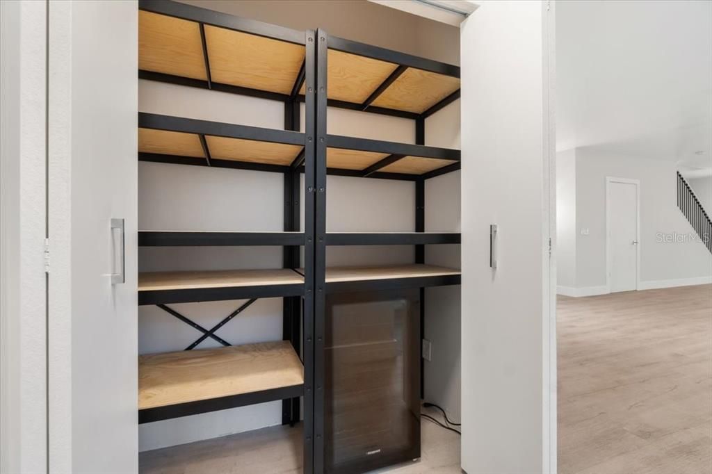 Pantry with Wine Fridge across from Laundry Room