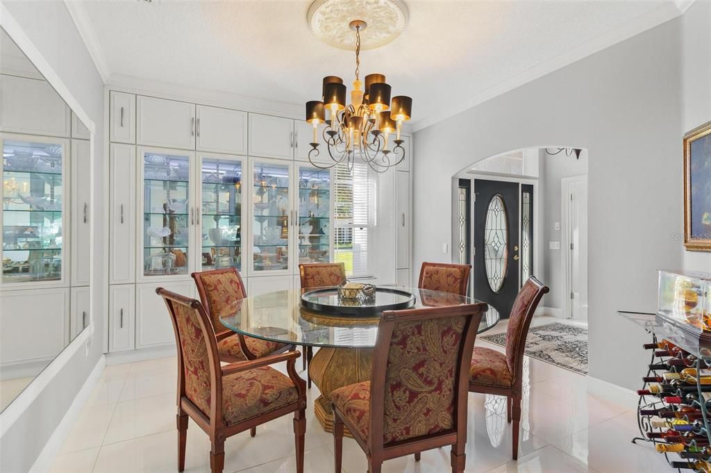 Formal Dining Area with a Wall to Wall Custom Built-China Cabinet with European-Style Drawers