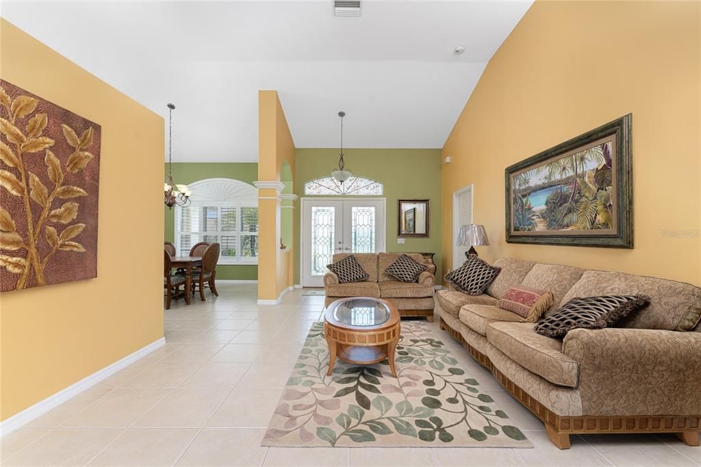 Living room view into the dining area and to the front door.