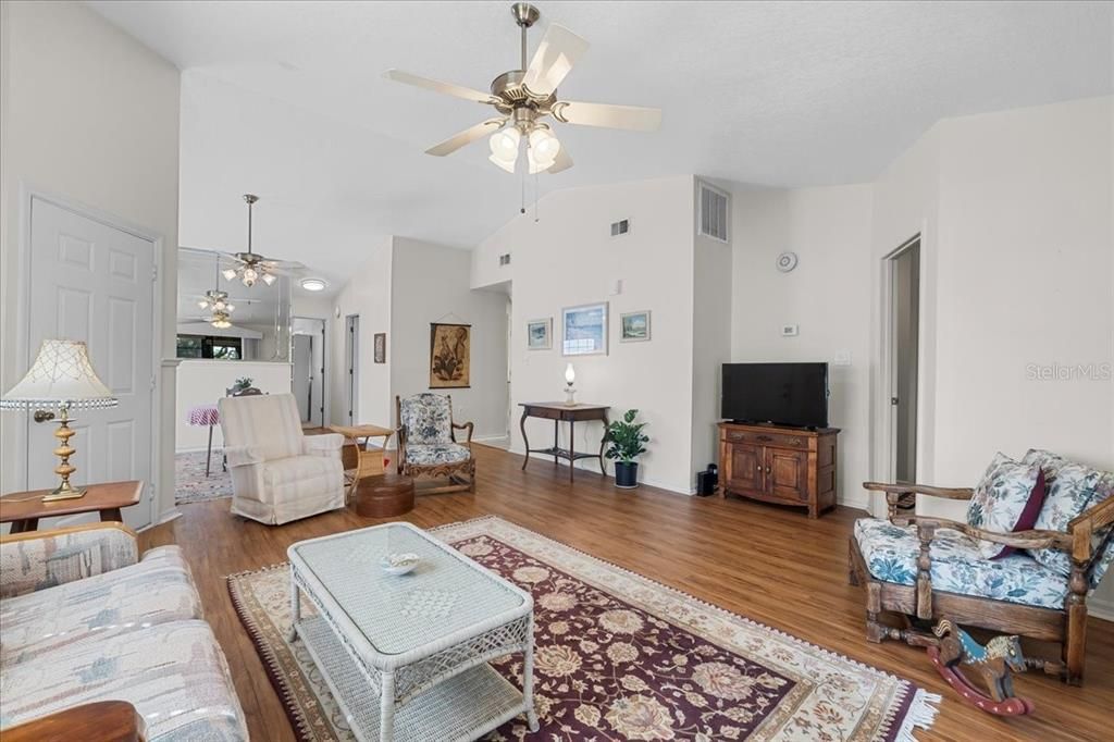 Open, airy, sun-filled Living Room looking into Dining Room