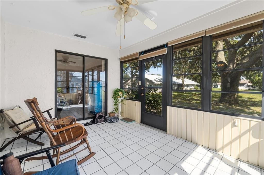 Your air-conditioned Sun Room, with real ceramic tile, wall 'o windows, and ceiling fan, looks out onto your outside patio and a lovely open greenspace that's cared for by the POA. How delightful!