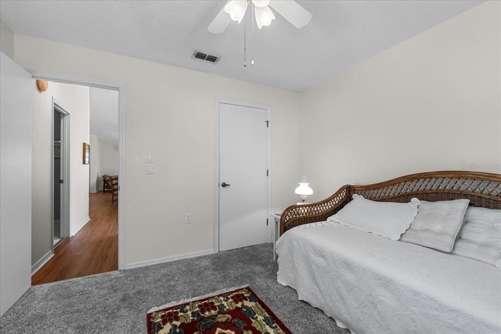 Second bedroom suite with its own walk-in closet, and a peek out toward the hall closet and second full bath.