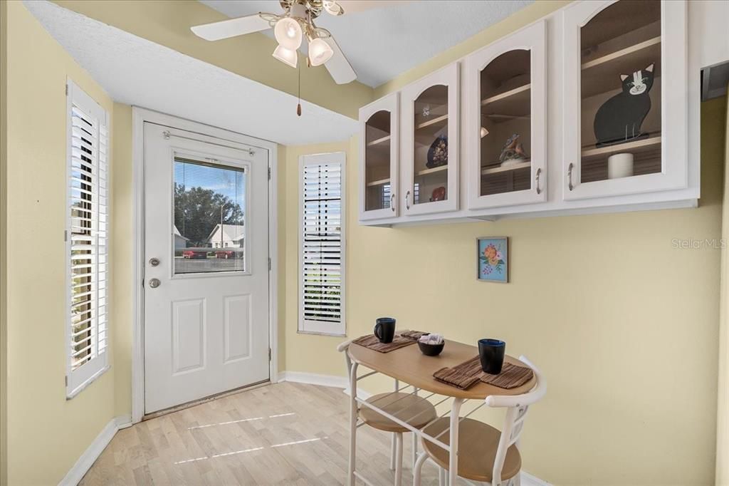 Eat-in kitchen with plantation shutters, ceiling fan, and lots of cabinet space