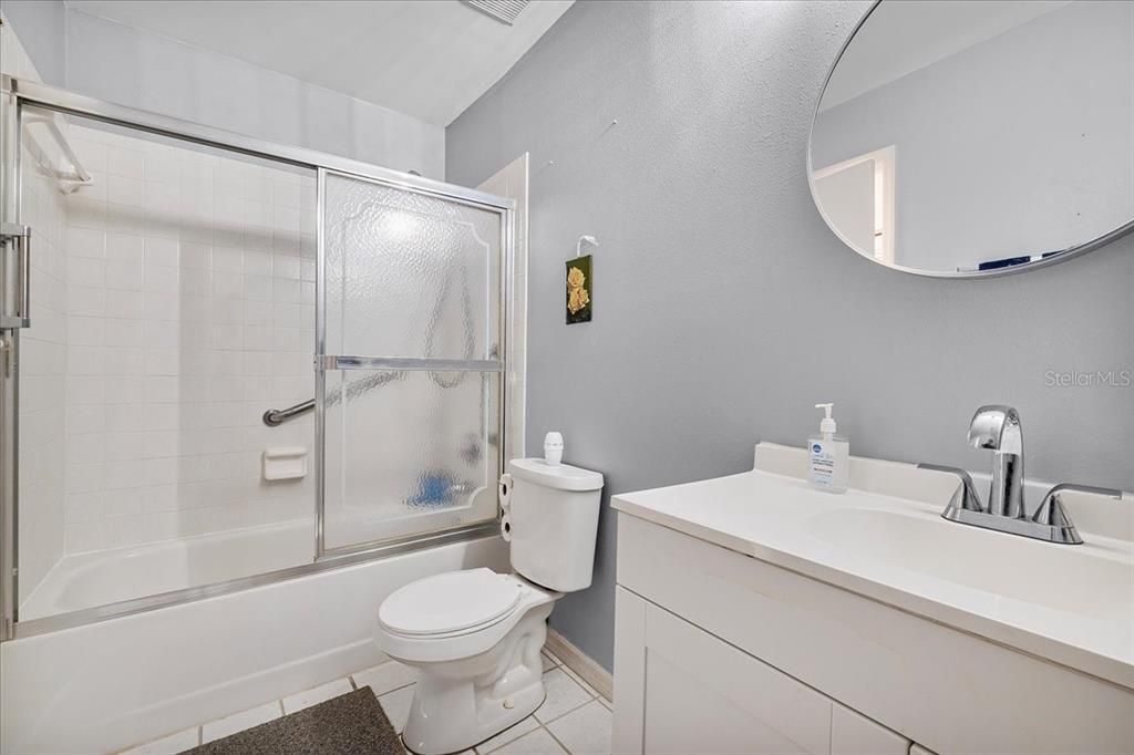 Second full bath, with updated cabinetry, glass shower doors, real tile shower/tub combo, and grab bars for that extra secure feeling when your feet are wet.