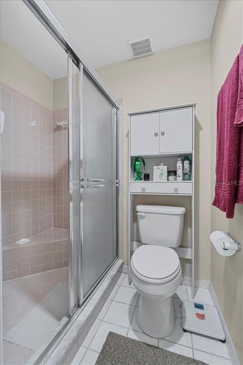 Owner's Oasis ensuite bath has glass shower doors, real tile shower, and a convenient corner shower seat.