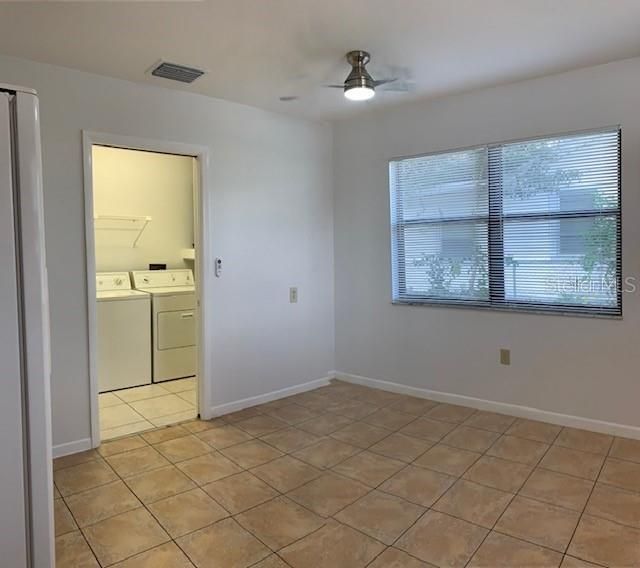 Eat-in kitchen with large laundry room and door access to back yard