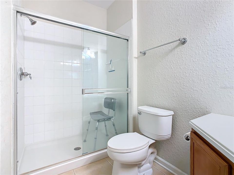 The guest bedroom has a walk-in closet and is located a short distance to the guest bathroom.