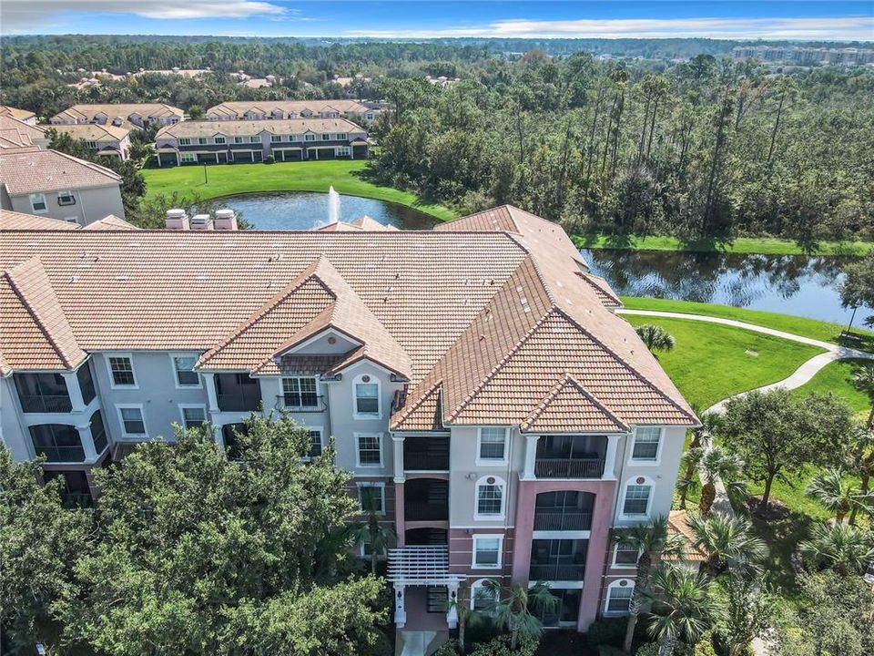 The unit is on the right side of the building with a view of the pond in the back.