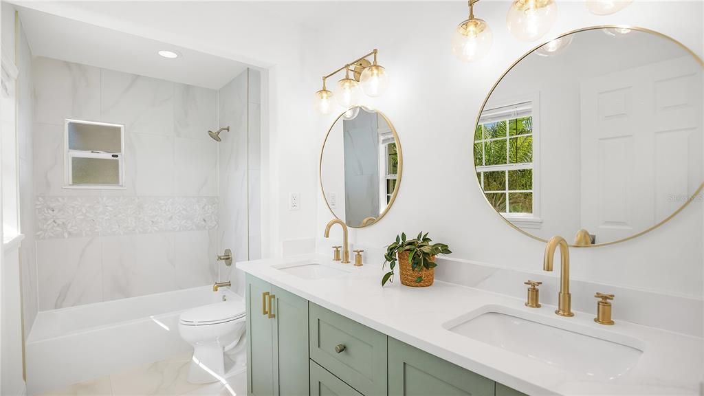 Absolutely STUNNING primary private bath with custom cabinetry with drawers, Kohler sink, Kohler toilet and Kohler Tub and shower with gold hardware.