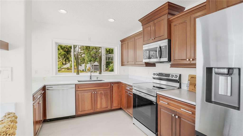 Updated kitchen with brand new stainless steel appliances, farm sink and spectacular quartz countertops.