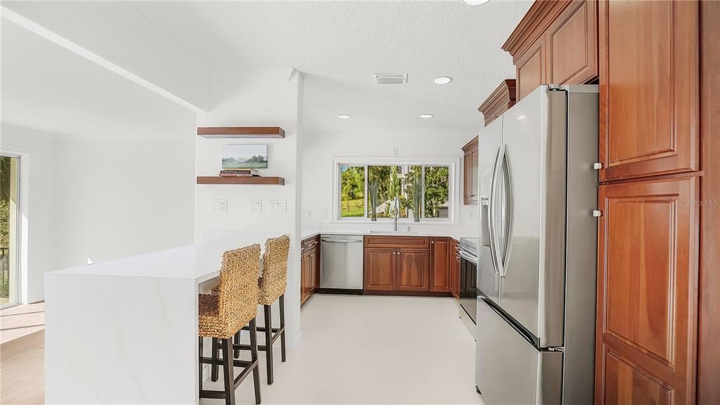 New waterfall quartz counter perfect eat-in space in kitchen