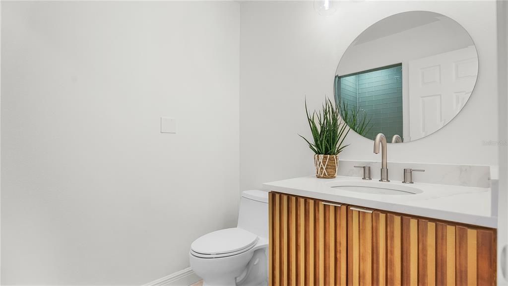 Incredible guest bathroom with custom cabinet and Kohler sink and 1 piece toilet.