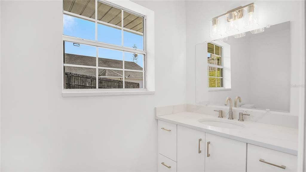 New half bath in garage with quartz countertop perfect for entertaining!