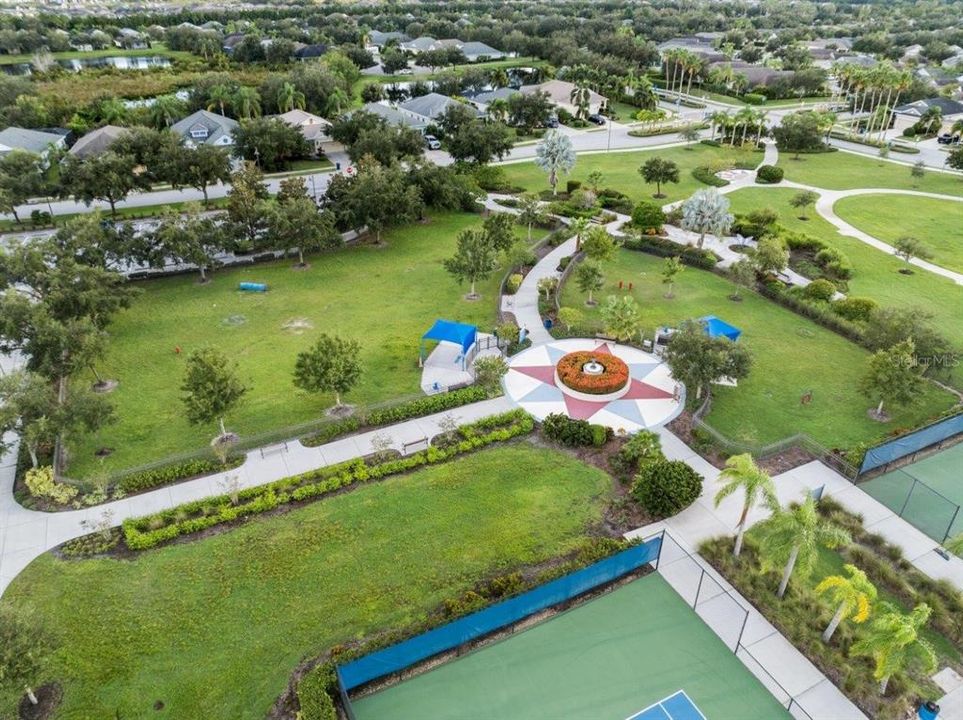 Central Park's amenities featuring a sports field, dog parks, splash pad, playground, and more!