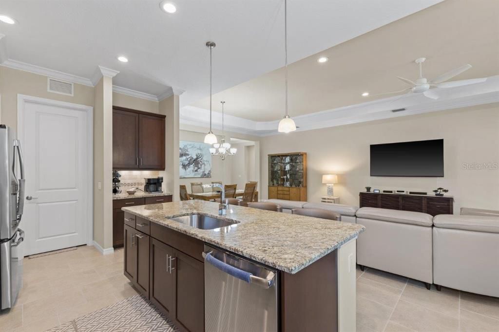 Stunning kitchen featuring granite countertops, stainless steel appliances, wood cabinets, and a dinette.