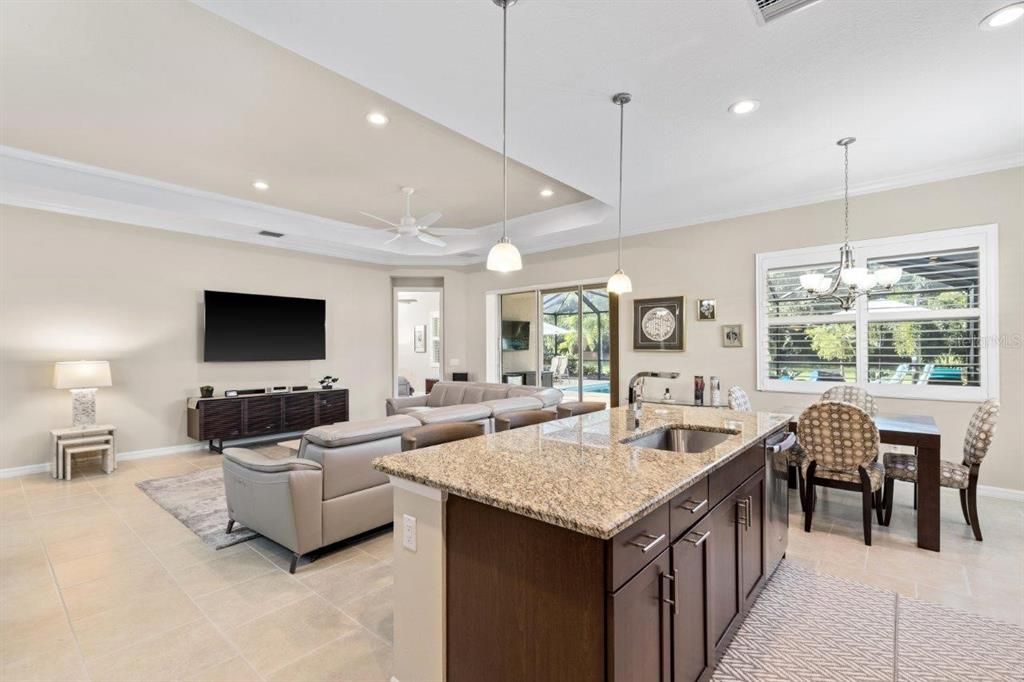 Stunning kitchen featuring granite countertops, stainless steel appliances, wood cabinets, and a dinette.