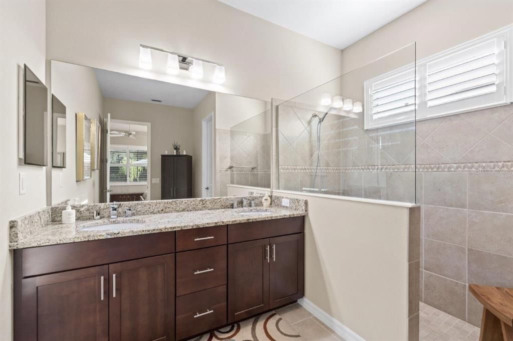 Owners ensuite bathroom featuring dual sinks, and a walk-in shower.